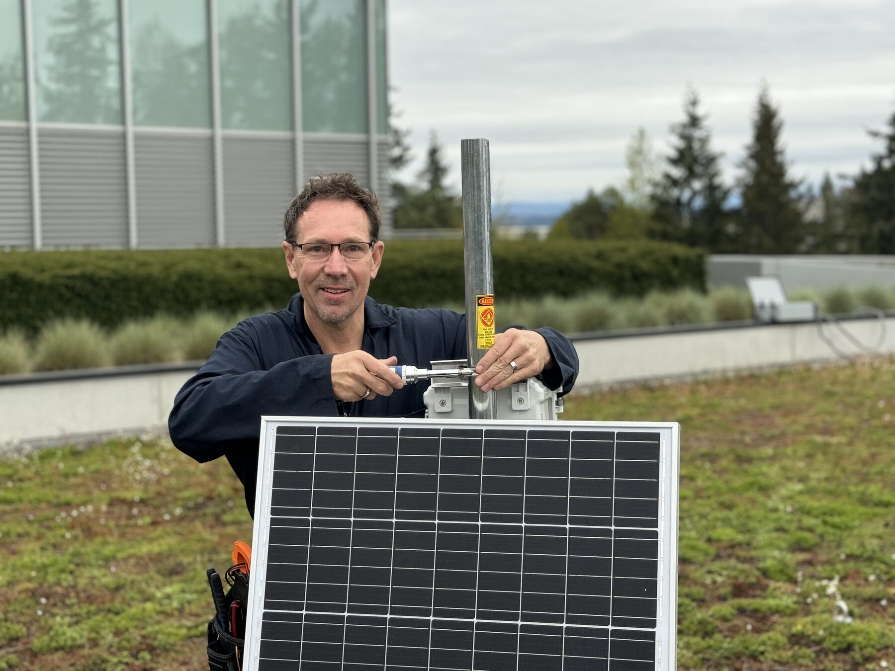 Andy Humphrey installing a solar-powered gateway on a green roof